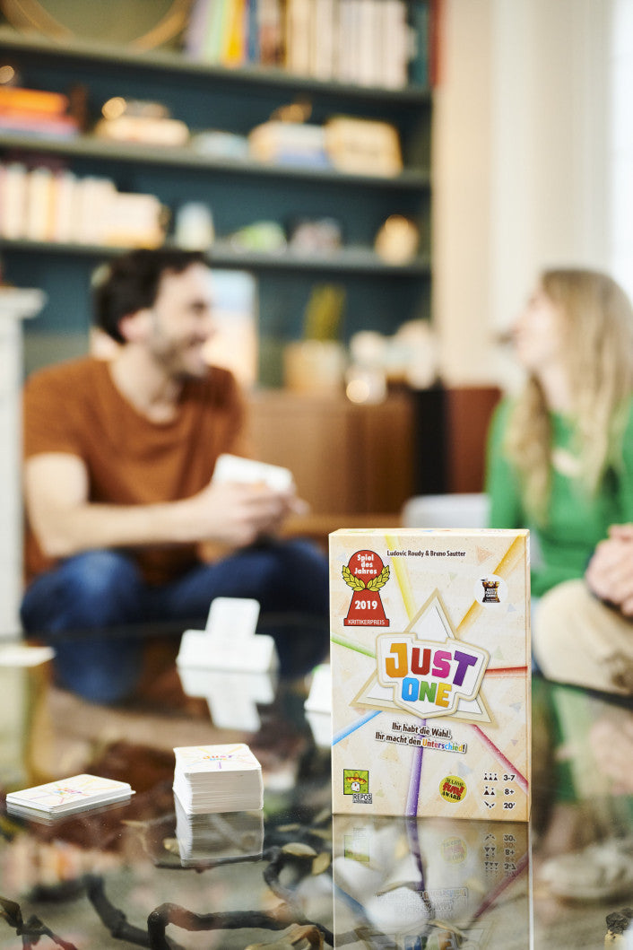 Just One board game box with clue cards and markers